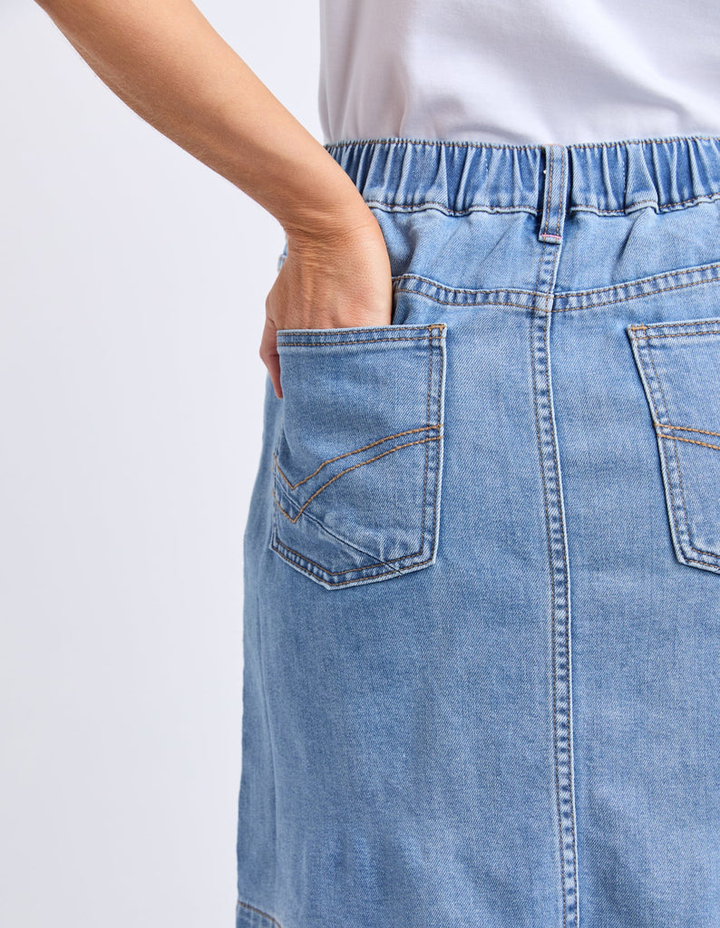 Birdie Denim Skirt - Light Blue Wash-Elm-The Birdie Denim Skirt brings playful charm with its comfy elastic at the side seams and back waist, giving you the perfect fit every time. Its knee-length cut is easygoing and flattering, while the Elm-stamped hardware adds a fun, unique touch to this effortlessly stylish skirt. Elastic at side seams and back waist Elm stamped hardware Flattering knee length 99% cotton 1% elastane stretch denim Model is 171cm and wears Size 10-Pash + Evolve
