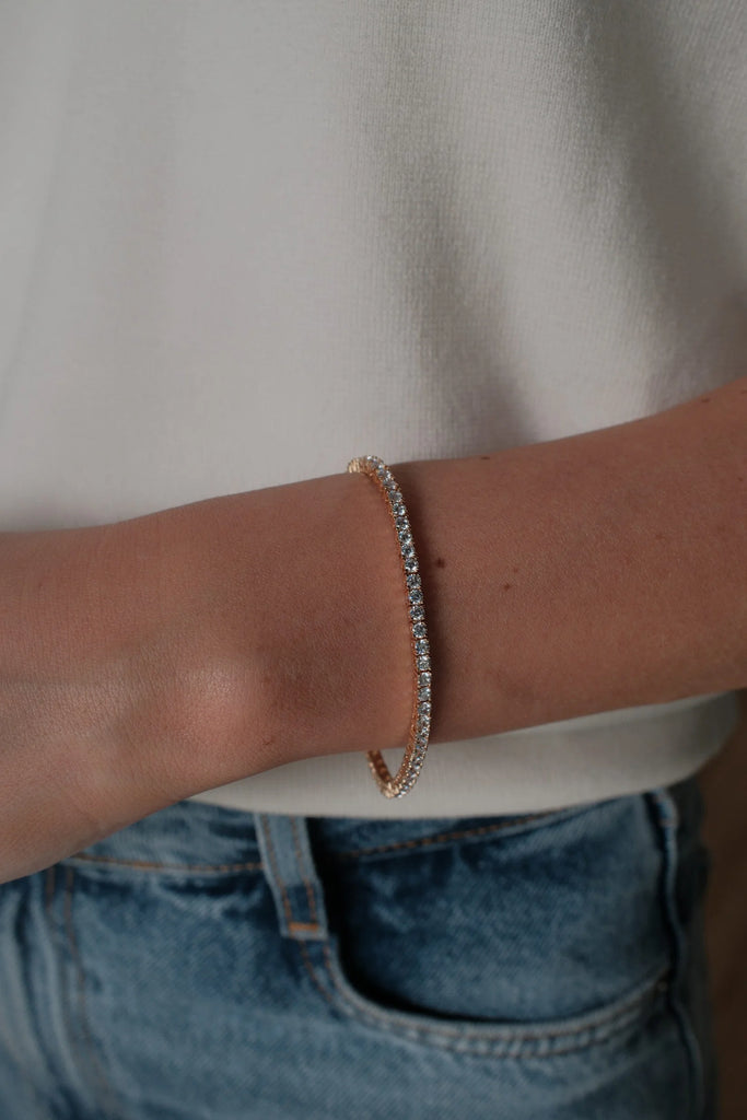 Dani tennis bracelet - gold-Zafino-The matching bracelet to our viral Dani Tennis Necklace. This timeless piece features a row of shimmering crystals set in gold, offering the perfect balance of elegance and everyday wear. Metal: 18K Gold Plated on BrassDimensions: 16.5cm LengthWater Resistant: Splash proof, not recommended to be worn in the ocean or pool-Pash + Evolve