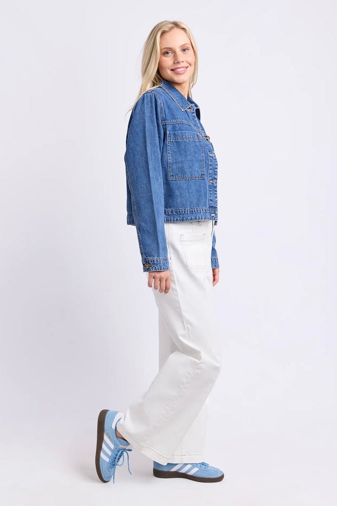 Essie Denim Jacket - Mid Blue Wash-Elm-The Essie Denim Jacket is a fresh take on a classic layer. Designed with a cropped length, relaxed fit and chest patch pockets, it adds just the right amount of structure to everyday outfits. Throw it over a tee dress, pair it with wide-leg pants or wear it with contrasting denim for an easy double-denim moment. Chest patch pockets Cropped length Rigid denim Relaxed fit 100% cotton denim The Model is 173cm and is wearing a size 10-Pash + Evolve