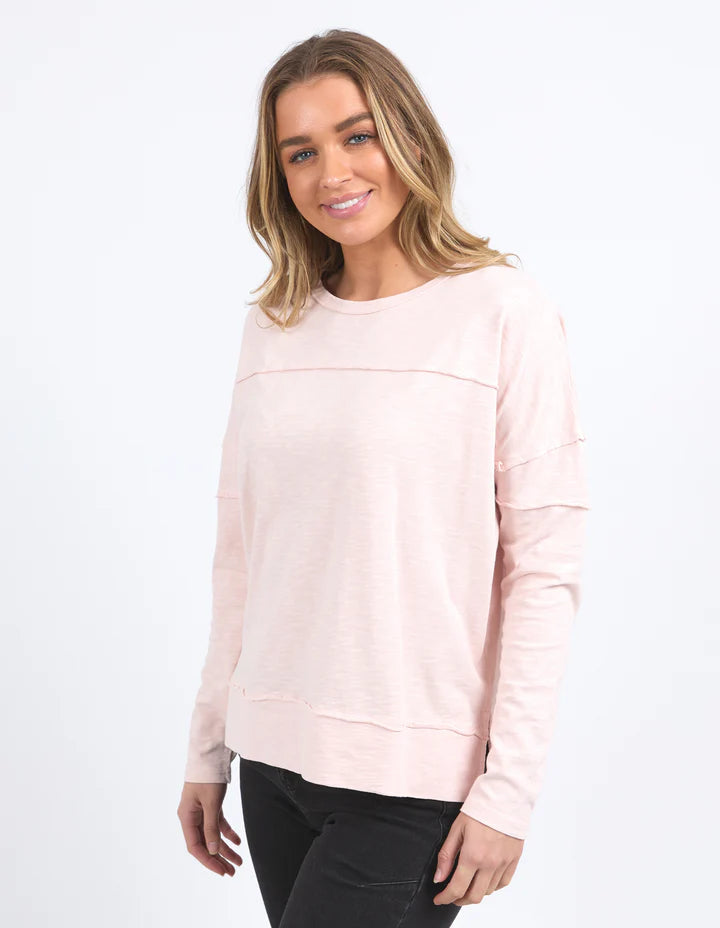 Jayne Throw On Top - Pale Pink-Foxwood-The Jayne Throw on Top is the perfect lightweight long sleeve to take you through the seasons. Cut from a comfy, cotton slub jersey this women's top features a crew neck, trendy exposed stitching and side split hi-low hem. Seriously versatile we know you'll be wearing this on repeat. Round neckline Design lines Raw edge details 100% Cotton Our model is 176cm and wears Size 10-Pash + Evolve