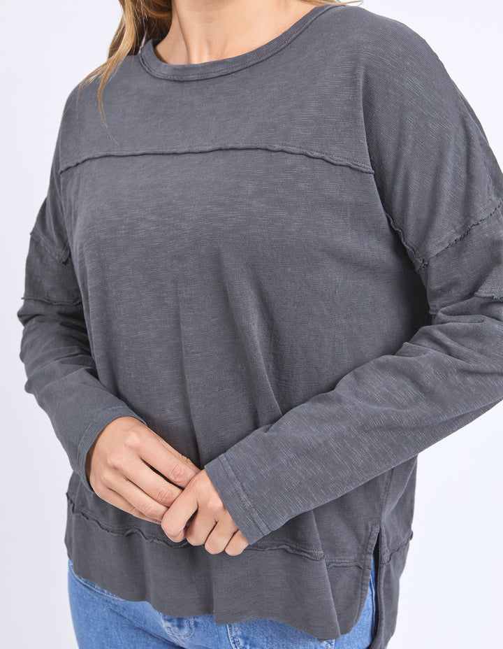 Jayne throw on top - charcoal-Foxwood-The Jayne Throw on Top is the perfect lightweight long sleeve to take you through the seasons. Cut from a comfy, cotton slub jersey this women's top features a crew neck, trendy exposed stitching and side split hi-low hem. Seriously versatile we know you'll be wearing this on repeat. Round neckline Design lines Raw edge details 100% Cotton Model is wearing a size 10-Pash + Evolve
