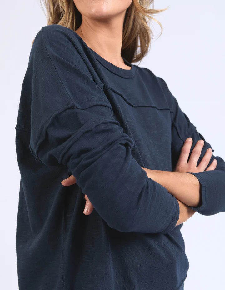 Jayne throw on top - navy-Foxwood-The Jayne Throw on Top is the perfect lightweight long sleeve to take you through the seasons. Cut from a comfy, cotton slub jersey this women's top features a crew neck, trendy exposed stitching and side split hi-low hem. Seriously versatile we know you'll be wearing this on repeat. Round neckline Design lines Raw edge details 100% Cotton Our model is 176cm and wears Size 10-Pash + Evolve