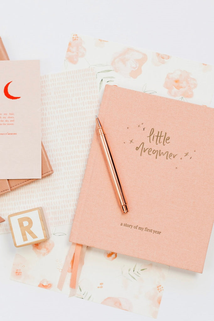 Little dreamer baby journal - petal-Pash + Evolve-A keepsake to be passed down to your little dreamer.A memento to imprint those moments easily forgotten in the fog of early parenthood.A journal of the milestones and memories, the hilarious and heart-warming.A time capsule of your little one’s history, heritage and home. Designed in collaboration with Gemma Peanut. FEATURES: Eighteen tabbed chapters, documenting pregnancy, parent profiles, family, birth and each month for the first twelve months of a little