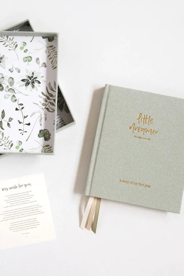 Little dreamer baby journal - sage-Pash + Evolve-A keepsake to be passed down to your little dreamer.A memento to imprint those moments easily forgotten in the fog of early parenthood.A journal of the milestones and memories, the hilarious and heart-warming.A time capsule of your little one’s history, heritage and home. Designed in collaboration with Gemma Peanut. FEATURES: Eighteen tabbed chapters, documenting pregnancy, parent profiles, family, birth and each month for the first twelve months of a little