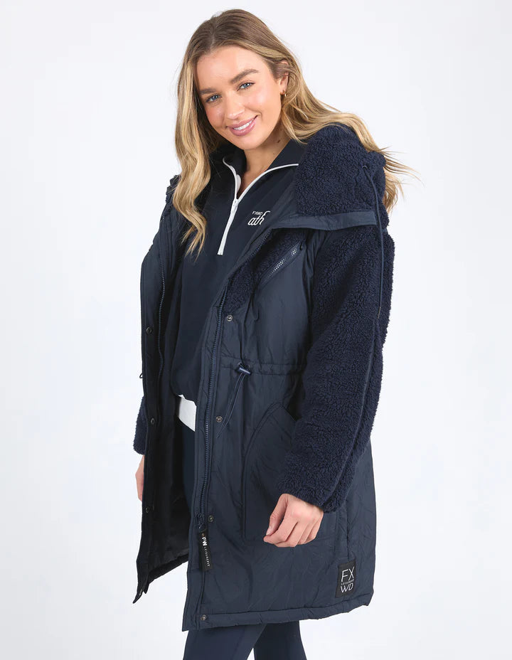 Longline Anorak - Navy-Foxwood-Be sure to stay snuggly warm on those cold days in the LeisureFit Longline Anorak. Featuring a zip and button opening for extra warmth, along with an elastic waist for flattering comfort this is the only layer you'll need this season. Front zip and button opening Contrast teddy fleece panels Elastic waist 100% Nylon Lining: 100% Polyester Model is wearing a size 10-Pash + Evolve