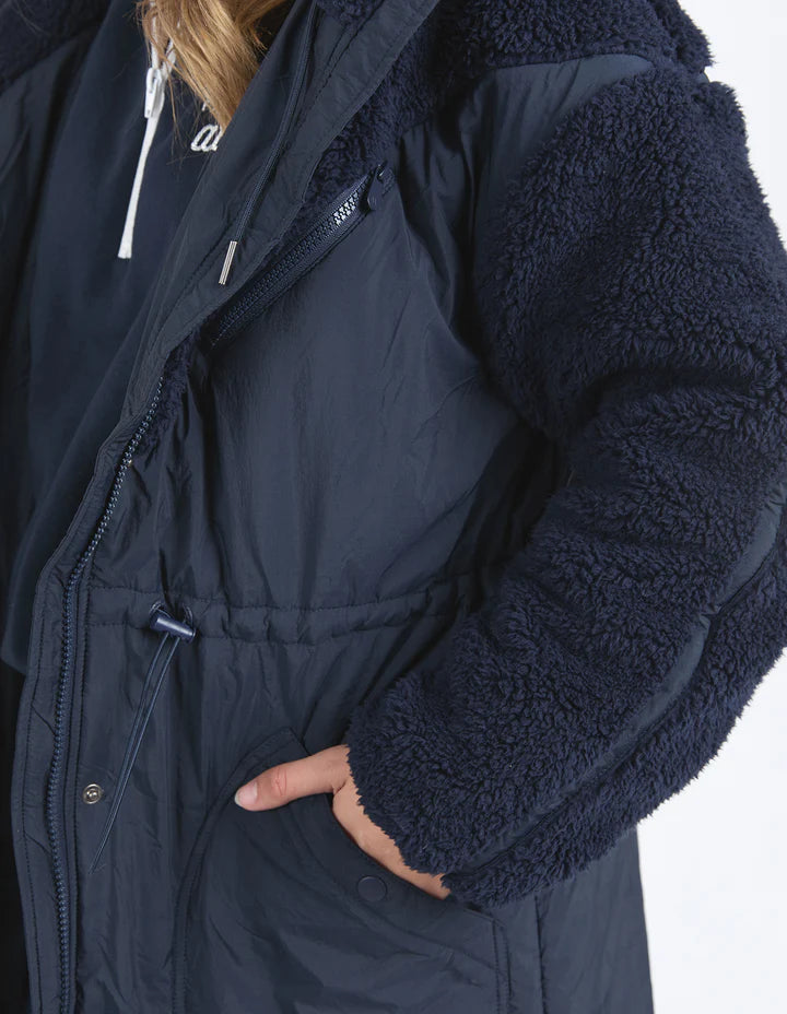 Longline Anorak - Navy-Foxwood-Be sure to stay snuggly warm on those cold days in the LeisureFit Longline Anorak. Featuring a zip and button opening for extra warmth, along with an elastic waist for flattering comfort this is the only layer you'll need this season. Front zip and button opening Contrast teddy fleece panels Elastic waist 100% Nylon Lining: 100% Polyester Model is wearing a size 10-Pash + Evolve