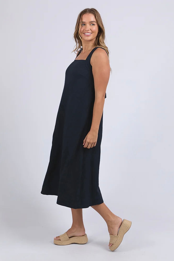 Lourdes dress - navy-Foxwood-Easy going with a playful twist. The Lourdes Dress (Foxwood Clothing) features a relaxed fit with an open back, layered underlay, and a sweet back tie detail that brings the charm. Light, floaty and full of personality—this one’s made for warm days and fun plans. Relaxed fit Wide straps Back tie detail Open back with under layer 55% Linen / 45% Viscose-Pash + Evolve
