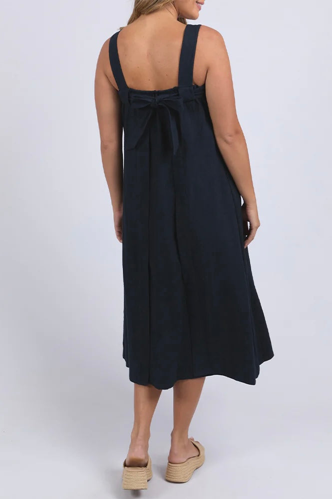 Lourdes dress - navy-Foxwood-Easy going with a playful twist. The Lourdes Dress (Foxwood Clothing) features a relaxed fit with an open back, layered underlay, and a sweet back tie detail that brings the charm. Light, floaty and full of personality—this one’s made for warm days and fun plans. Relaxed fit Wide straps Back tie detail Open back with under layer 55% Linen / 45% Viscose-Pash + Evolve