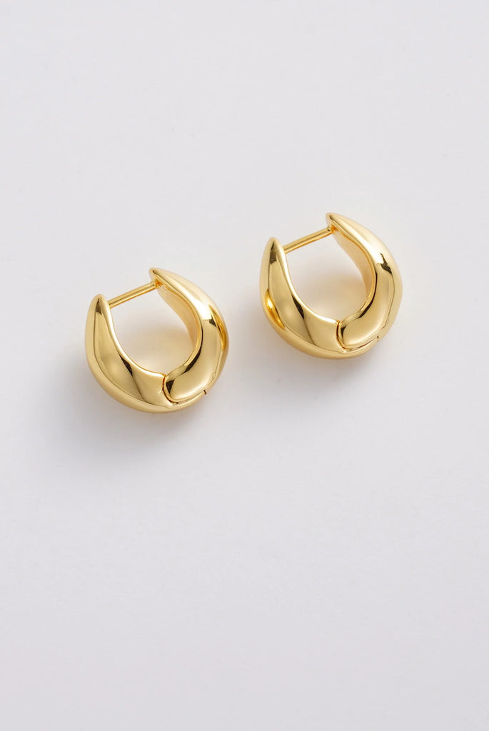 Margot Hoop - Gold-Zafino-The Margot Hoop features a bold, sculptural silhouette with a smooth, high-polish gold finish. Its rounded, tapered shape creates a modern statement while remaining timeless and versatile for everyday styling. Designed to elevate both casual and dressy looks, Margot adds a refined, fashion-forward touch to any jewellery collection. Metal: 18K gold plated on brass base Dimensions: 15.9mm outer diameter, 8.6mm inner diameter + 7.7mm width Water Resistant: Handle occasional water exp
