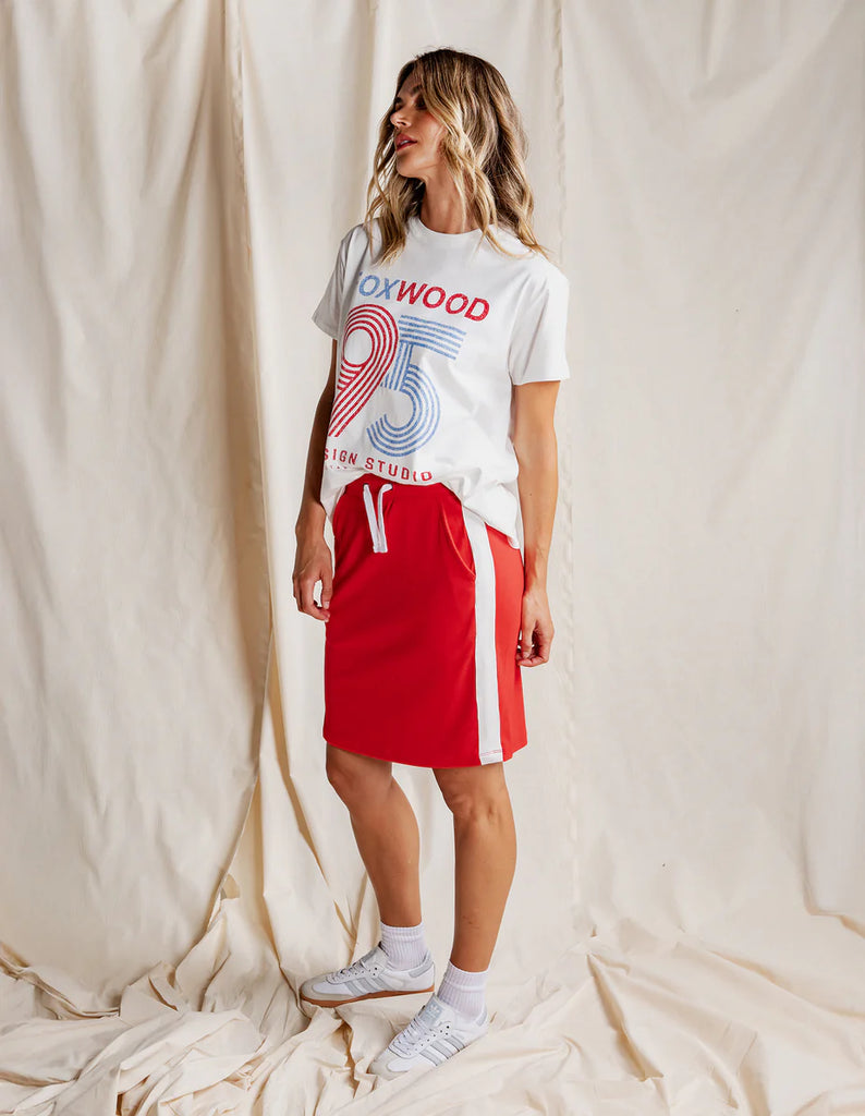 Market Skirt - Red-Foxwood-Power through your day in the Market Skirt. Featuring on-trend side contrast tape, a comfy elastic waist, and handy side pockets, this skirt blends casual cool with effortless style. Made from lightweight fabric, it’s the perfect piece to elevate your everyday wardrobe. Elastic waist Side pockets Side contrast tape detail 100% Cotton Model is wearing a size 10-Pash + Evolve