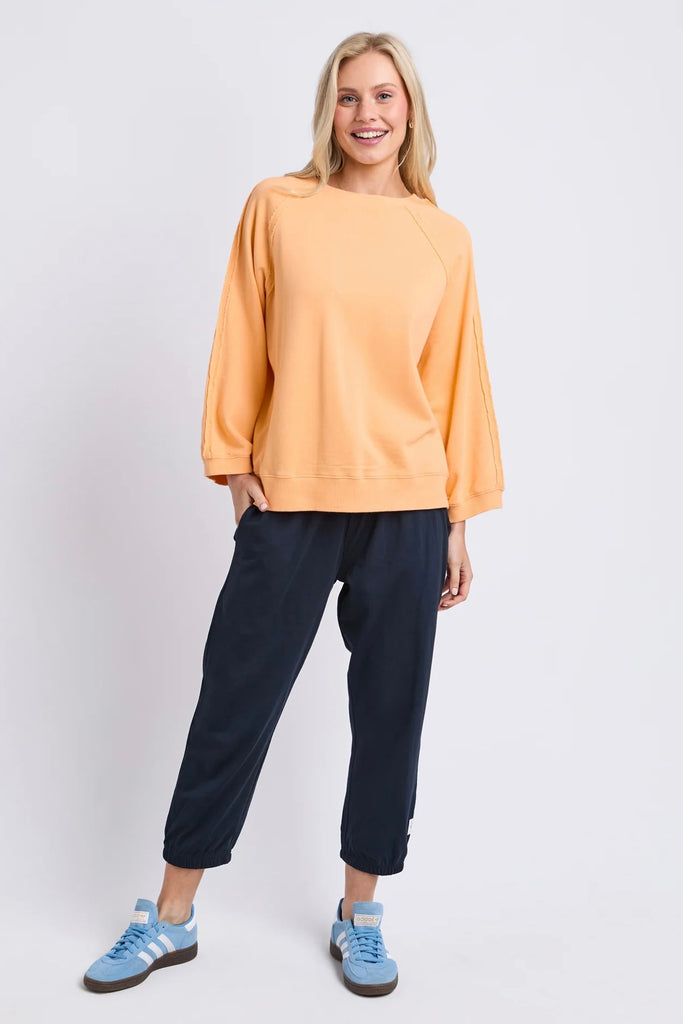 Nessa sweat - peach-Elm-Crafted from premium Australian cotton fleece, the Nessa Sweat features raglan sleeves and sporty taping details for an elevated casual look. Pair it with denim or lounge pants for everyday comfort. Raglan sleeves Rib at cuffs & hemband Taping at sleeves Relaxed fit 100% Australian Cotton Un-brushed Fleece The Model is 173cm and is wearing a size 10-Pash + Evolve