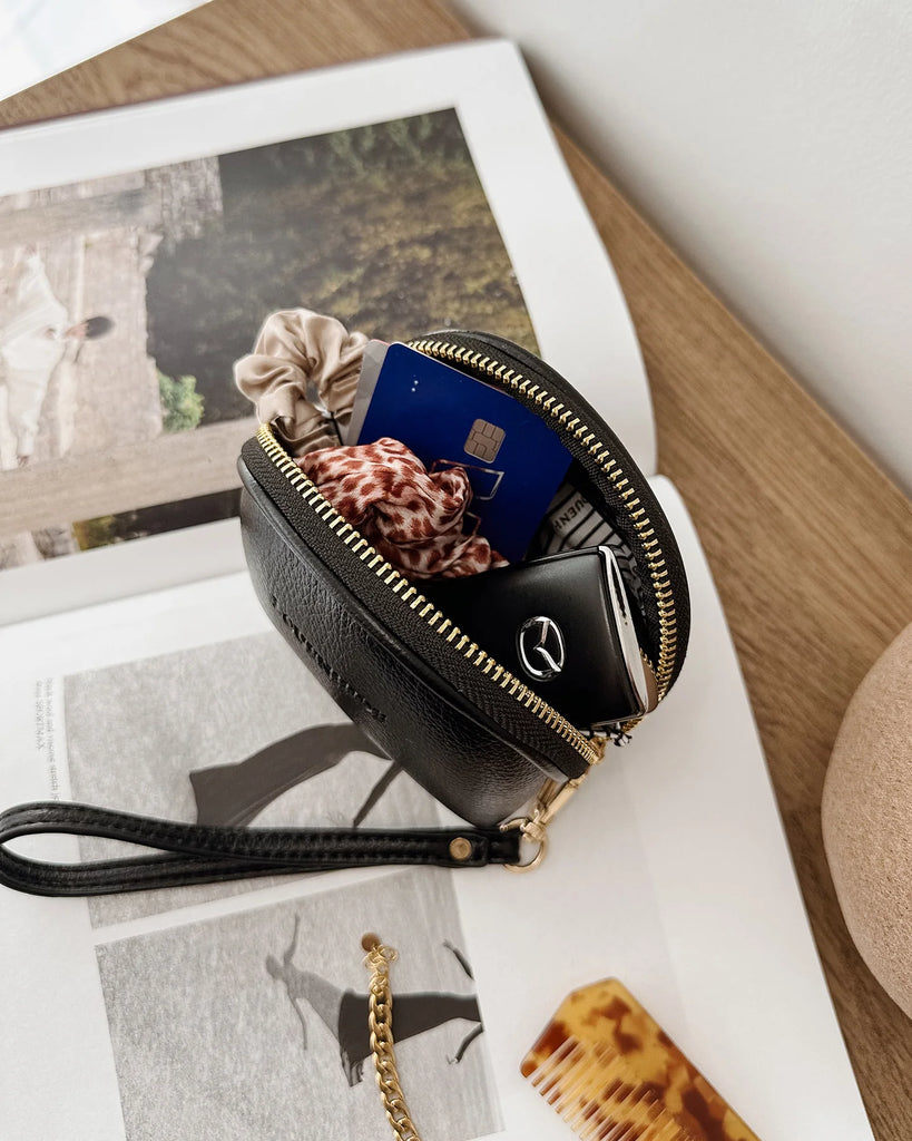 Paige Purse - Black-Louenhide-The Louenhide Paige Black Purse is the little essential you didn’t know your bag was missing. Designed with a compact round silhouette, this coin purse is perfect for keeping your valuables secure without taking up space. Whether it’s loose change, small essentials, or tiny treasures, this pouch slips effortlessly into any bag, ready to go wherever the day leads. Versatile yet refined, the Paige Black Purse is a simple solution for staying organised. External Features Detachabl