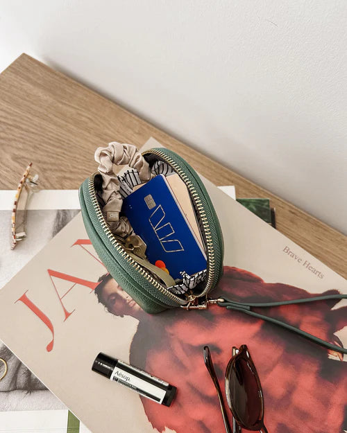 Paige purse - forest green-Louenhide-The Louenhide Paige Forest Green Purse is the little essential you didn’t know your bag was missing. Designed with a compact round silhouette, this coin purse is perfect for keeping your valuables secure without taking up space. Whether it’s loose change, small essentials, or tiny treasures, this pouch slips effortlessly into any bag, ready to go wherever the day leads. Versatile yet refined, the Paige Forest Green Purse is a simple solution for staying organised. Extern