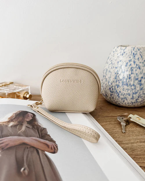Paige purse - oat-Louenhide-The Louenhide Paige Oat Purse is the little essential you didn’t know your bag was missing. Designed with a compact round silhouette, this coin purse is perfect for keeping your valuables secure without taking up space. Whether it’s loose change, small essentials, or tiny treasures, this pouch slips effortlessly into any bag, ready to go wherever the day leads. Versatile yet refined, the Paige Oat Purse is a simple solution for staying organised. External Features Detachable Wris