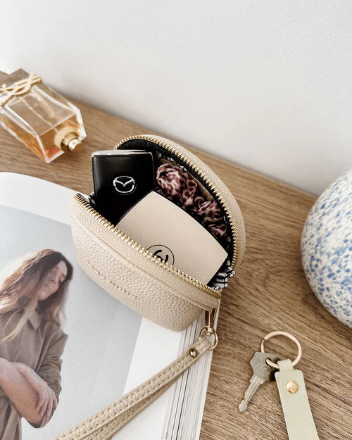 Paige purse - oat-Louenhide-The Louenhide Paige Oat Purse is the little essential you didn’t know your bag was missing. Designed with a compact round silhouette, this coin purse is perfect for keeping your valuables secure without taking up space. Whether it’s loose change, small essentials, or tiny treasures, this pouch slips effortlessly into any bag, ready to go wherever the day leads. Versatile yet refined, the Paige Oat Purse is a simple solution for staying organised. External Features Detachable Wris