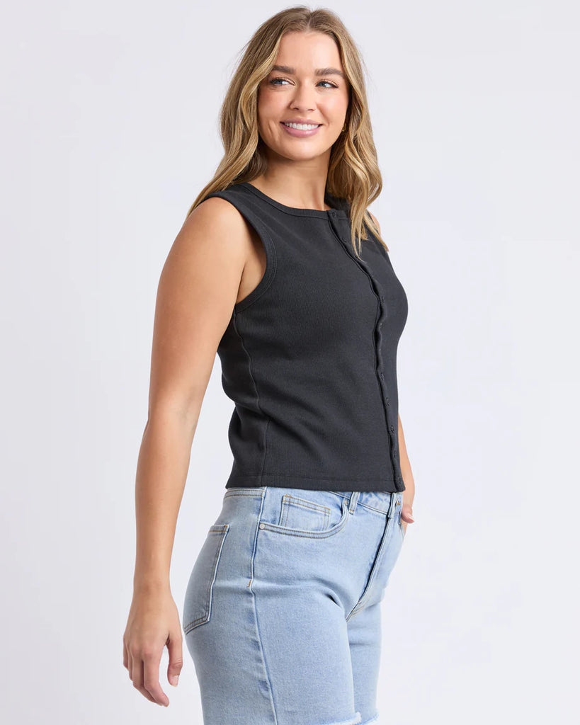 Raf Button Through Tank - Black-Foxwood-The Raf Button Through Tank is your new go-to for sleek, easy styling. Featuring a full button front and crafted from a soft, double-layer rib fabric, it offers a comfortable, flattering fit that moves with you. Perfect for layering or wearing on its own with denim or linen for a polished off-duty look. Front button opening Double layer rib fabric Fitted style 94% Cotton / 6% Elastane Model is wearing a size 10-Pash + Evolve