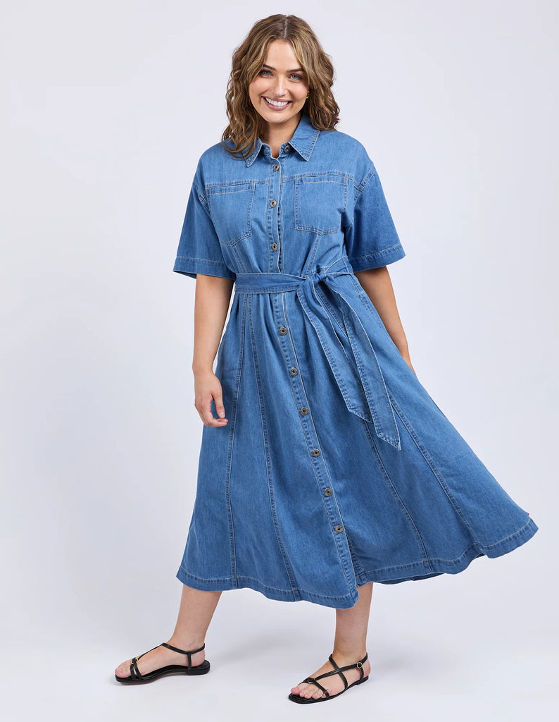 River Denim Dress - Mid Blue Wash-Elm-The River Denim Dress is a lovely long-line dress with a tie waist and button through shirt style dress that looks just as great worn with some comfy sneakers as it does teamed with a sandal or boot. Versatility is key with this dress. Shirt dress style with self fabric waist tie Panel details at skirt Side seam pockets Rigid Denim Model is 171cm and wears Size 10-Pash + Evolve
