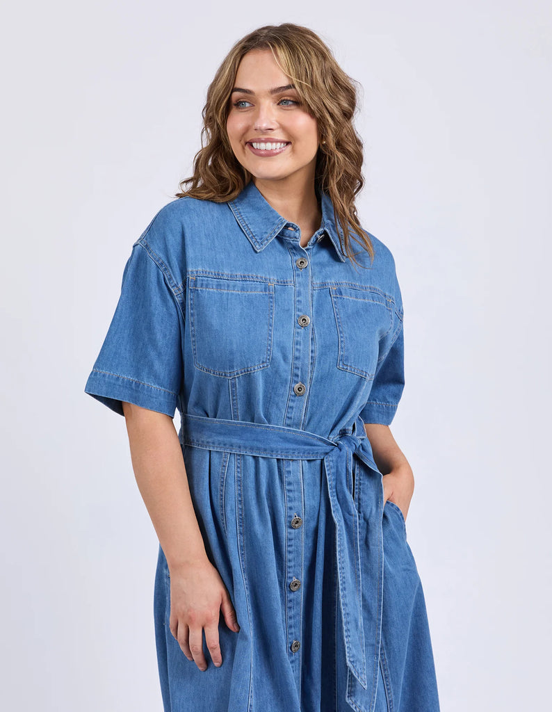 River Denim Dress - Mid Blue Wash-Elm-The River Denim Dress is a lovely long-line dress with a tie waist and button through shirt style dress that looks just as great worn with some comfy sneakers as it does teamed with a sandal or boot. Versatility is key with this dress. Shirt dress style with self fabric waist tie Panel details at skirt Side seam pockets Rigid Denim Model is 171cm and wears Size 10-Pash + Evolve