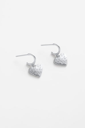 Romy hoop - silver-Zarla-A relaxed take on a classic hoop. Finished with a softly textured heart charm, this piece brings an easy, beachy feel with just the right amount of shine. Effortless, sun-worn, and made to be worn every day. *Rhodium Plated Solid Brass Base *Water proof: Can be worn in the ocean or pool-Pash + Evolve
