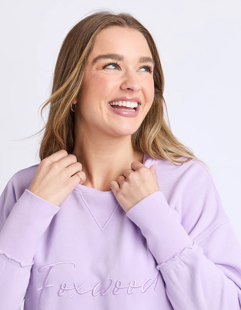 Signature Crew - Orchid-Foxwood-Our must-have Signature Crew is the perfect mix of comfort and style. Featuring classic Foxwood embroidery on the chest, this crew is all about the little details—think raw edge finishes and a flattering curved hemline. Designed for everyday ease, it’s your go-to layer for those laid-back, effortlessly cool looks. Front chest embroidery Raw edge detail Curved hem 100% Cotton Our model is 176cm and wears Size 10-Pash + Evolve