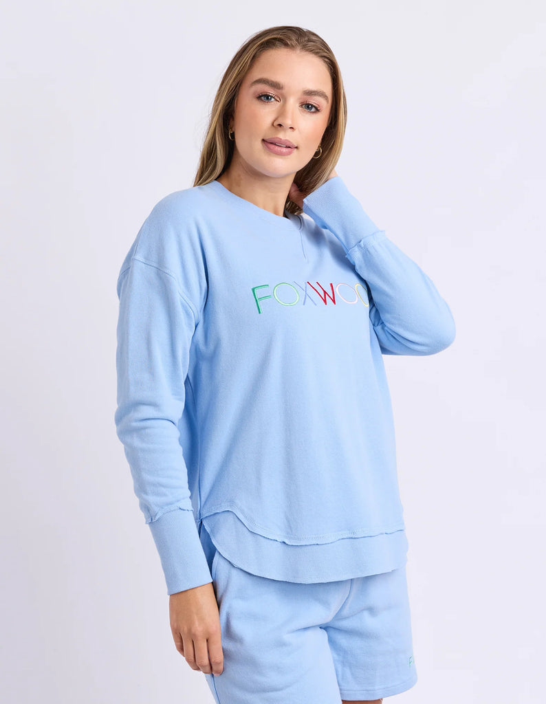 Simplified Confetti Crew - Bluebell-Foxwood-Say hello to your new feel-good fave. The Simplified Confetti Crew brings all the comfort with a playful twist. With multicoloured embroidery on the chest, raw edge details, and a curved hem that flatters every fit, it's the kind of piece you'll want to wear on repeat. Easy to throw on, even easier to love. One colour just won’t be enough. Front chest multicoloured embroidery Raw edge detail Curved hem 100% Cotton Our model is 176cm and wears Size 10-Pash + Evolv