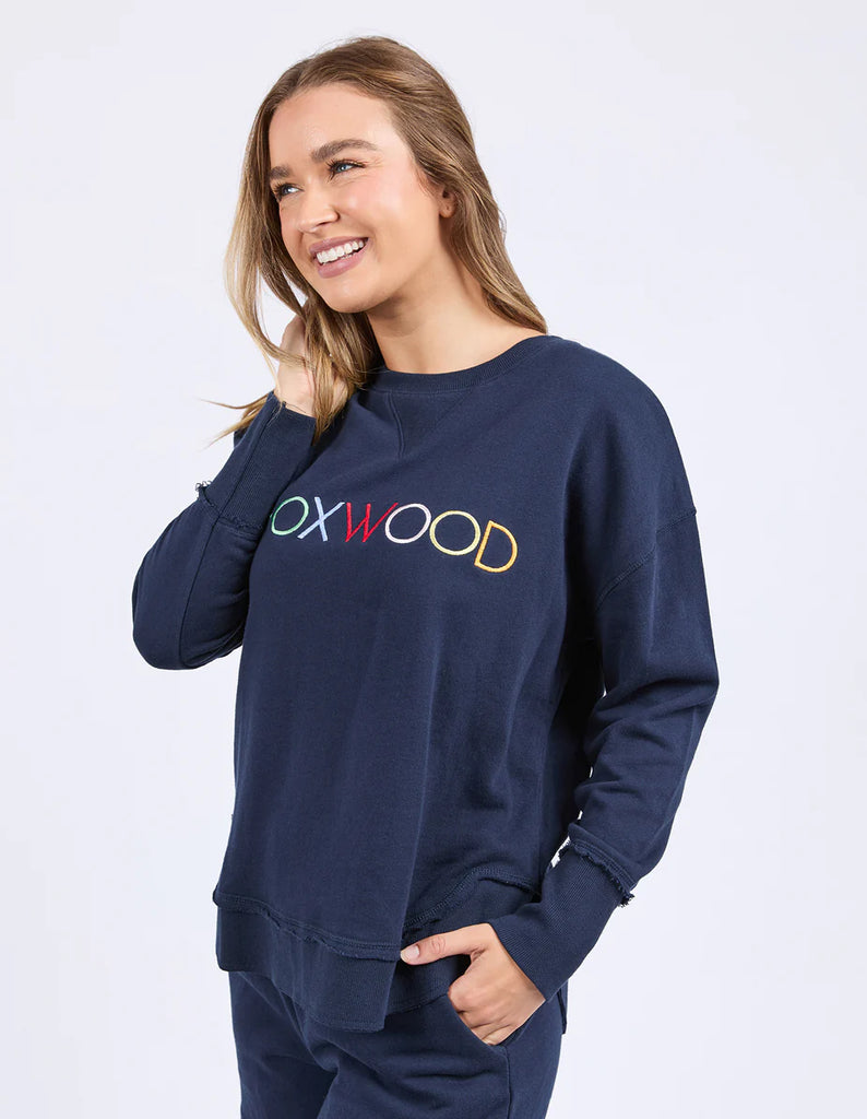 Simplified Confetti Crew - Navy-Foxwood-Say hello to your new feel-good fave. The Simplified Confetti Crew brings all the comfort with a playful twist. With multicoloured embroidery on the chest, raw edge details, and a curved hem that flatters every fit, it's the kind of piece you'll want to wear on repeat. Easy to throw on, even easier to love. One colour just won’t be enough. Front chest multicoloured embroidery Raw edge detail Curved hem 100% Cotton Model is wearing a size 10-Pash + Evolve