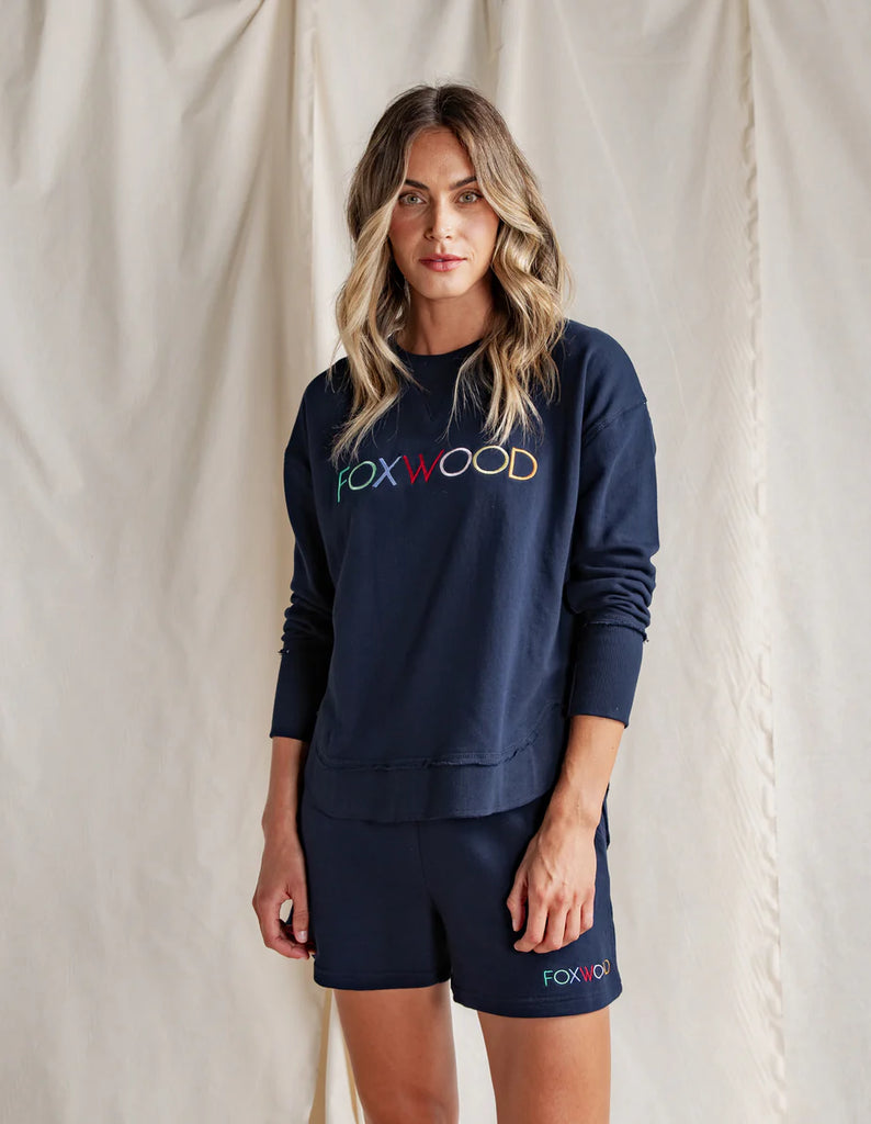 Simplified Confetti Crew - Navy-Foxwood-Say hello to your new feel-good fave. The Simplified Confetti Crew brings all the comfort with a playful twist. With multicoloured embroidery on the chest, raw edge details, and a curved hem that flatters every fit, it's the kind of piece you'll want to wear on repeat. Easy to throw on, even easier to love. One colour just won’t be enough. Front chest multicoloured embroidery Raw edge detail Curved hem 100% Cotton Model is wearing a size 10-Pash + Evolve