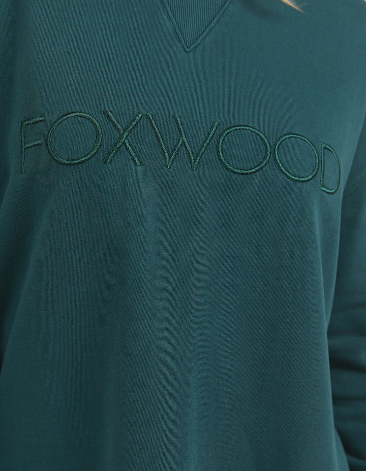 Simplified Crew - Forrest-Foxwood-The Simplified Crew is the perfect throw over for your everyday wardrobe. With its round neck, hi-lo hemline, side splits with raw edging & the classic Foxwood logo, you are going to want one in every colour. Front chest embroidery Raw edge detail Curved hem 100% Cotton Our model is 176cm and wears Size 10-Pash + Evolve