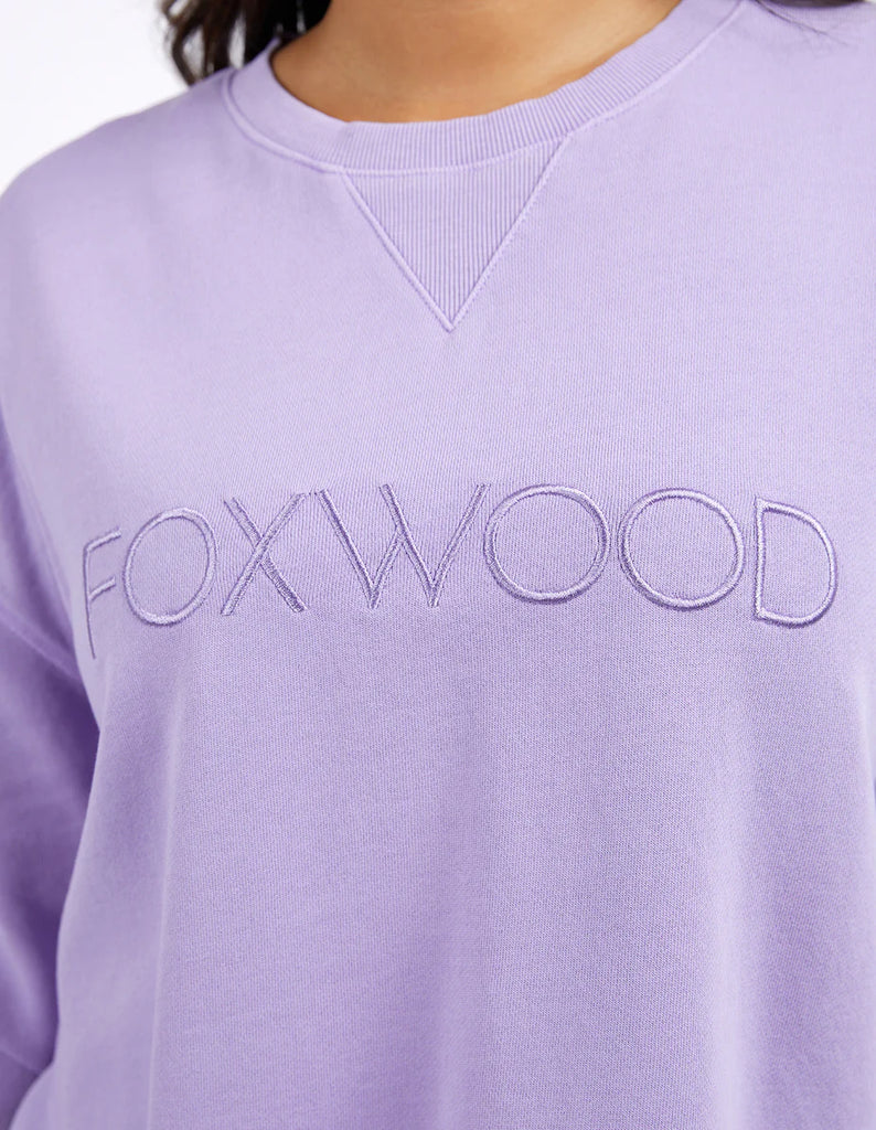 Simplified Crew - Lavender-Foxwood-The Simplified Crew is the perfect throw over for your everyday wardrobe. With its round neck, hi-lo hemline, side splits with raw edging & the classic Foxwood logo, you are going to want one in every colour. Front chest embroidery Raw edge detail Curved hem 100% Cotton Model is wearing a size 10-Pash + Evolve