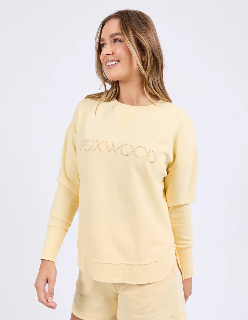 Simplified Crew - Lemon-Foxwood-The Simplified Crew is the perfect throw over for your everyday wardrobe. With its round neck, hi-lo hemline, side splits with raw edging & the classic Foxwood logo, you are going to want one in every colour. Front chest embroidery Raw edge detail Curved hem 100% Cotton Model is wearing a size 10-Pash + Evolve