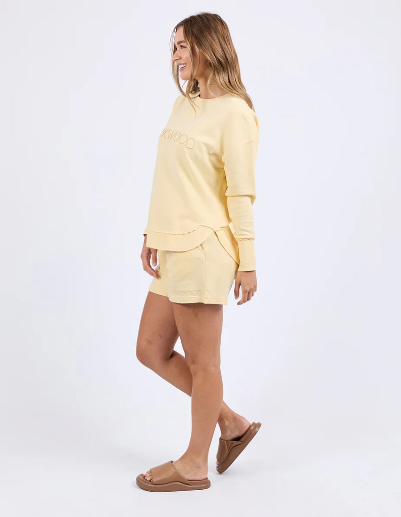 Simplified Crew - Lemon-Foxwood-The Simplified Crew is the perfect throw over for your everyday wardrobe. With its round neck, hi-lo hemline, side splits with raw edging & the classic Foxwood logo, you are going to want one in every colour. Front chest embroidery Raw edge detail Curved hem 100% Cotton Model is wearing a size 10-Pash + Evolve