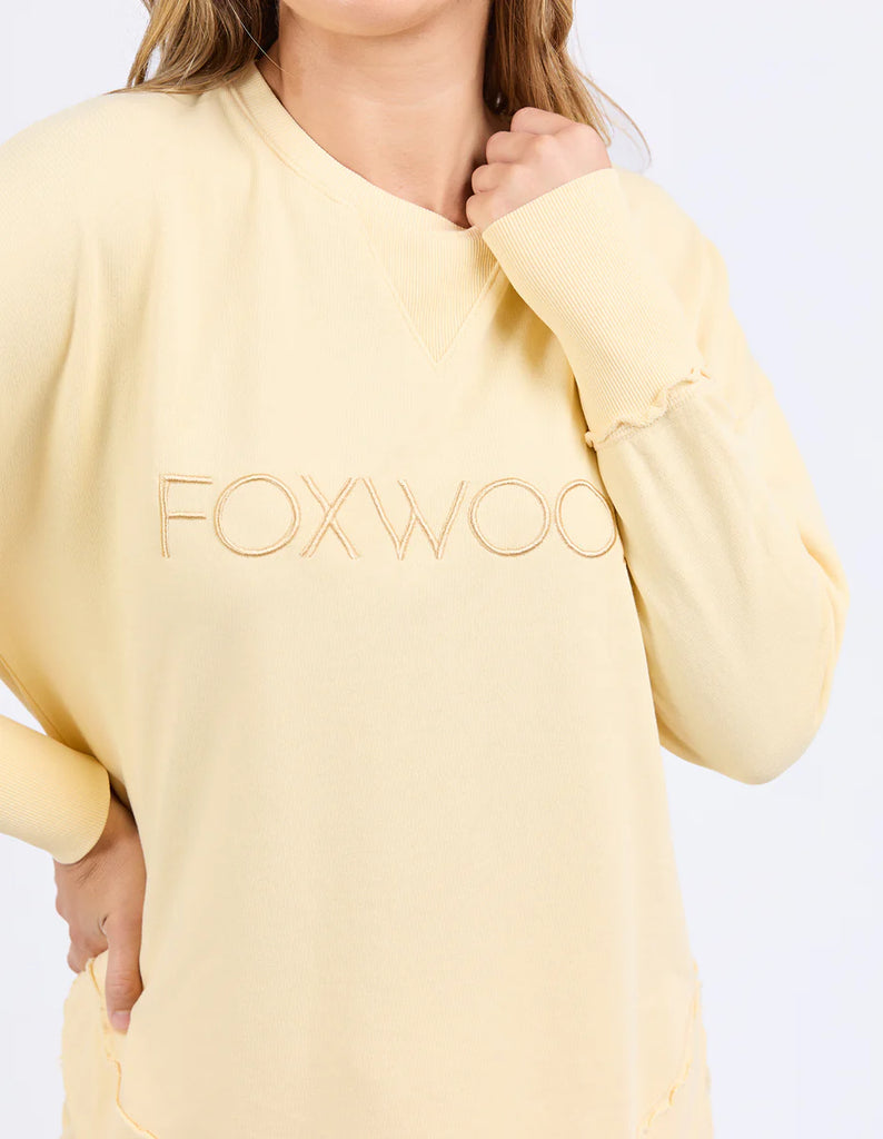 Simplified Crew - Lemon-Foxwood-The Simplified Crew is the perfect throw over for your everyday wardrobe. With its round neck, hi-lo hemline, side splits with raw edging & the classic Foxwood logo, you are going to want one in every colour. Front chest embroidery Raw edge detail Curved hem 100% Cotton Model is wearing a size 10-Pash + Evolve
