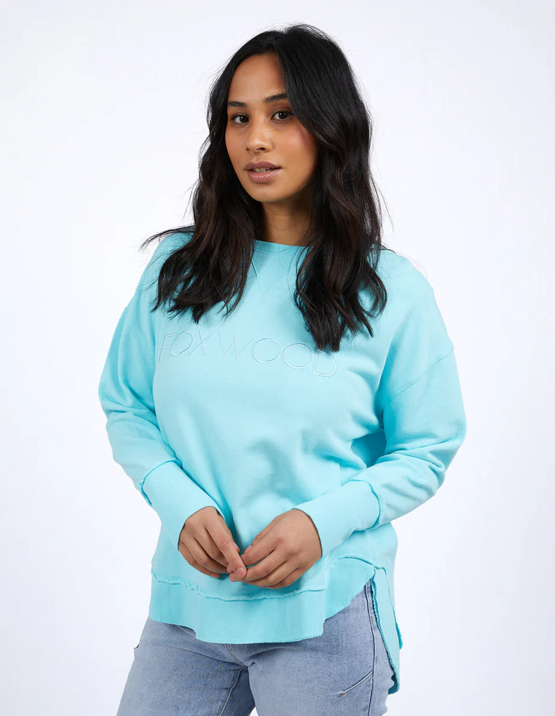 Simplified Crew - Light Blue-Foxwood-The Simplified Crew is the perfect throw over for your everyday wardrobe. With its round neck, hi-lo hemline, side splits with raw edging & the classic Foxwood logo, you are going to want one in every colour. Front chest embroidery Raw edge detail Curved hem 100% Cotton Our model is 176cm and wears Size 10-Pash + Evolve