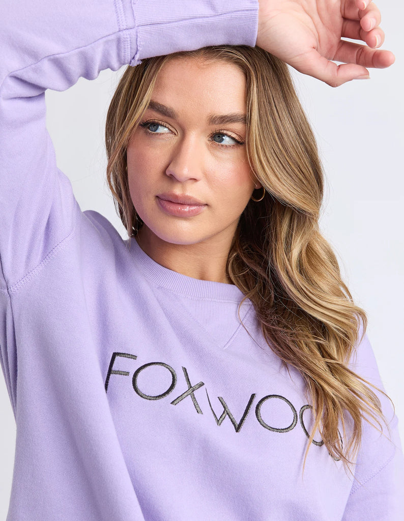 Simplified Metallic Crew - Lavender-Foxwood-The Bling version of our Best Selling Simplified Crew. This crew is the perfect throw over for your everyday wardrobe. With its round neck, hi-lo hemline, side splits with raw edging & the classic Foxwood logo, you are going to want one in every colour. The Metallic Crew has a stunning lurex thread run through the Foxwood embroidery for that little bit 'extra'. Front chest embroidery Raw edge detail Curved hem 100% Cotton Our model is 176cm and wears Size 10-Pash