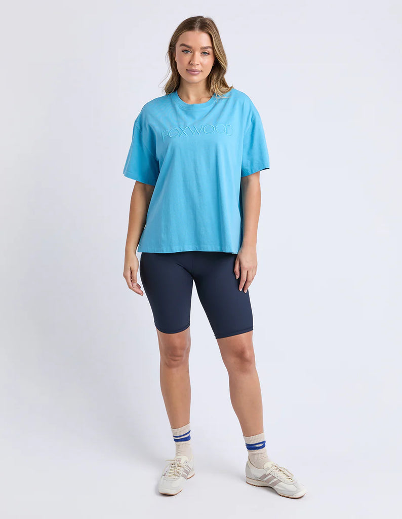 Simplified Tee - Sky-Foxwood-The Simplified Tee is the perfect throw over for your everyday wardrobe. With its round neck, hi-lo hemline, side splits with raw edging & the classic Foxwood logo, you are going to want one in every colour. Front chest embroidery Round neckline Relaxed fit 100% Cotton Our model is 176cm and wears Size 10-Pash + Evolve