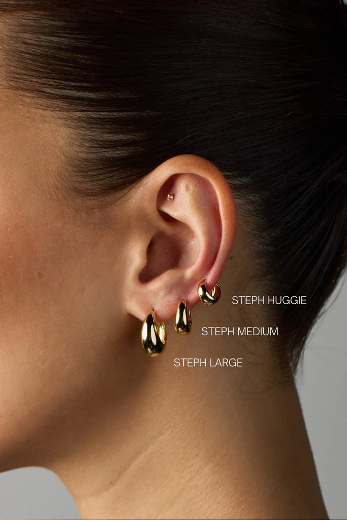 Steph hoop Medium - Gold-Zafino-Introducing the Medium Steph Hoops – a delicate and minimalist addition to your collection. Crafted with high-quality materials, these tear drop-shaped hoops offer durability and beauty. Their lightweight design and easy-to-wear closure ensure comfort throughout the day. Versatile and elegant, the Steph Hoop Earrings elevate any outfit, making them the ideal accessory for chic, understated style. Metal: 18K Gold Plated on BrassEarring Size: 5mm (W) x 12mm (L) Measured at the