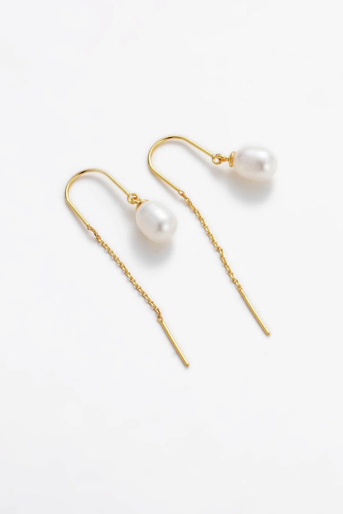 Talia Thread Earring - Gold-Zafino-The Talia Thread Earring is a delicate, contemporary design that blends simplicity with elegance. Featuring a single freshwater pearl suspended from a fine gold thread, this style offers fluid movement and a refined touch. Perfect for elevating everyday looks or adding understated glamour to evening wear, Talia is a versatile piece that’s as effortless as it is timeless. Metal: 18K Gold Plated on BrassDimensions: 7mm Pearl 46mm Drop (Length)Water Resistant: Splash proof,