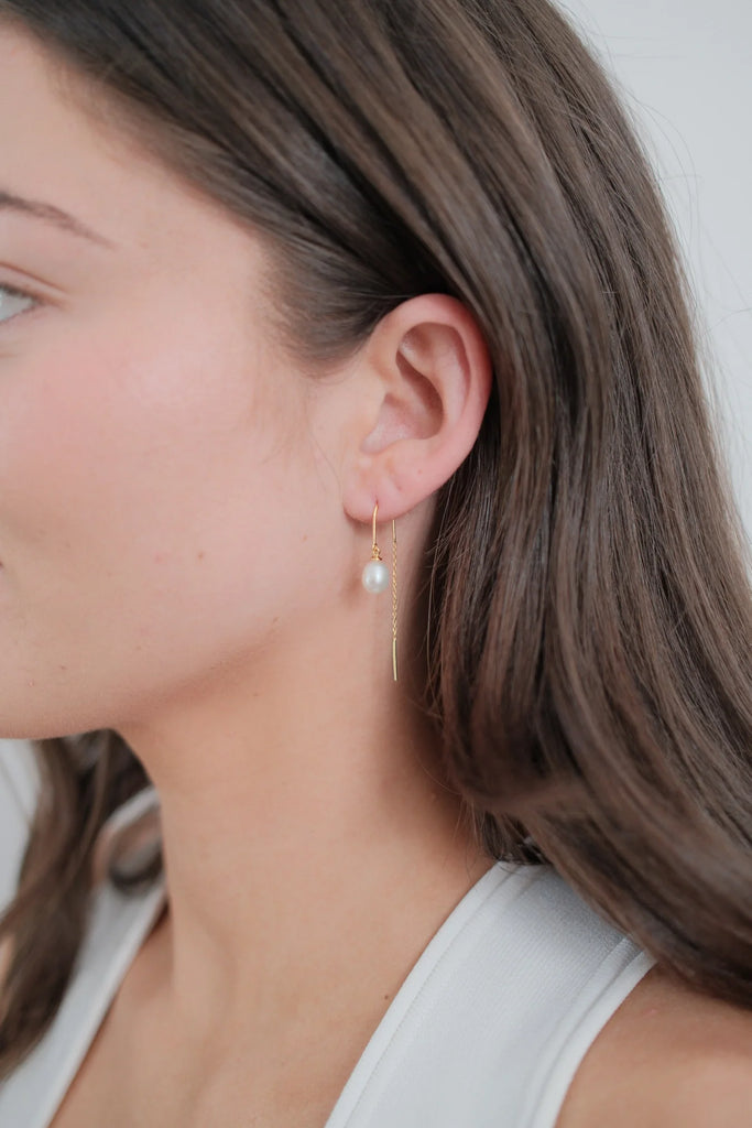Talia Thread Earring - Gold-Zafino-The Talia Thread Earring is a delicate, contemporary design that blends simplicity with elegance. Featuring a single freshwater pearl suspended from a fine gold thread, this style offers fluid movement and a refined touch. Perfect for elevating everyday looks or adding understated glamour to evening wear, Talia is a versatile piece that’s as effortless as it is timeless. Metal: 18K Gold Plated on BrassDimensions: 7mm Pearl 46mm Drop (Length)Water Resistant: Splash proof,