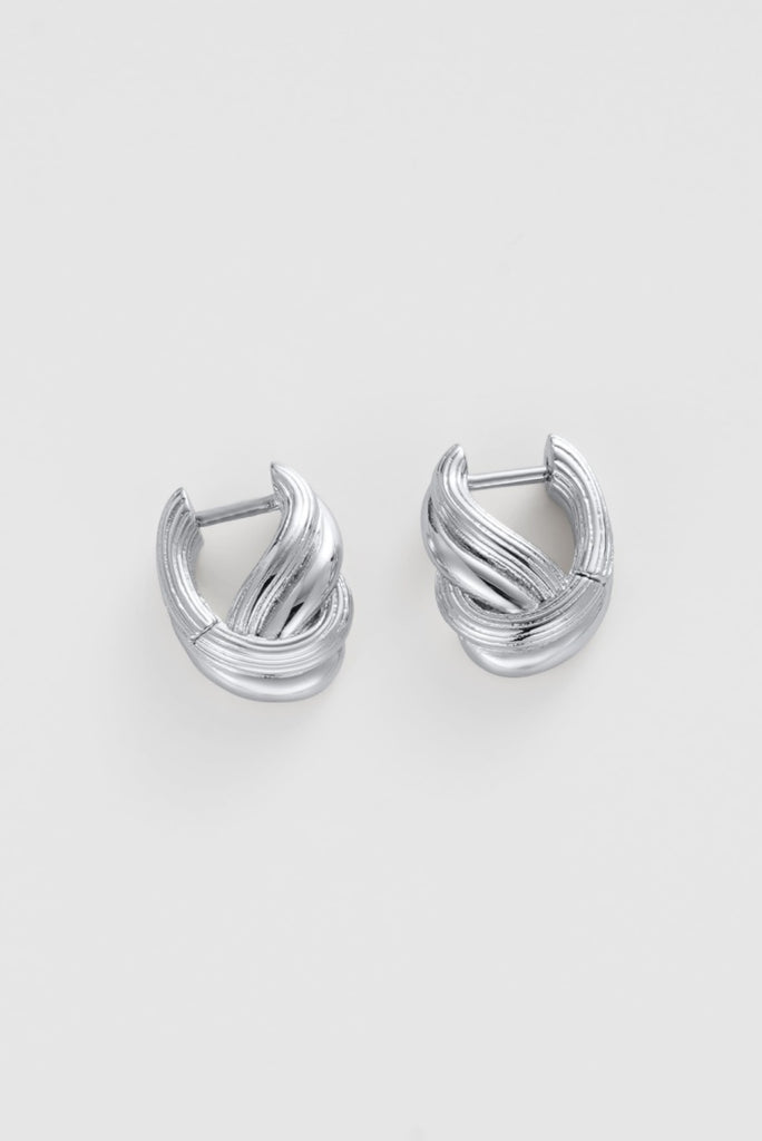 Tia huggie - silver-Zafino-The Tia Huggie in silver is a sculptural essential with a modern twist. Its layered, ribbed detailing and polished finish create a strong, light-catching texture. Perfect for adding depth to a stacked ear or worn alone as a statement, it’s a versatile piece that feels both elevated and wearable. A standout style with everyday appeal. Silver Plated Solid Brass Base 15mm outer diameter, 5.2mm width Water proof: Can be worn in the ocean or pool-Pash + Evolve