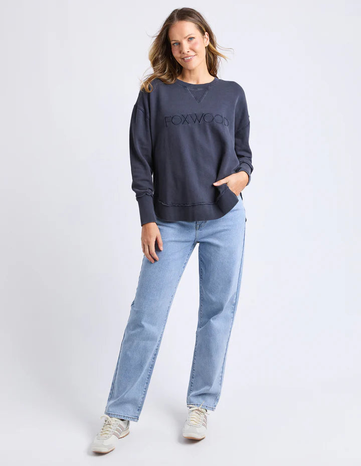 Washed Simplified Crew - Navy-Foxwood-The Washed version of our Best Selling Simplified Crew. This crew is the perfect throw over for your everyday wardrobe. With its round neck, hi-lo hemline, side splits with raw edging & the classic Foxwood logo, you are going to want one in every colour. The Washed version has a vintage look for that much-loved look from the get-go. Front chest embroidery Raw edge detail Curved hem 100% Cotton Model is wearing a Size 10-Pash + Evolve