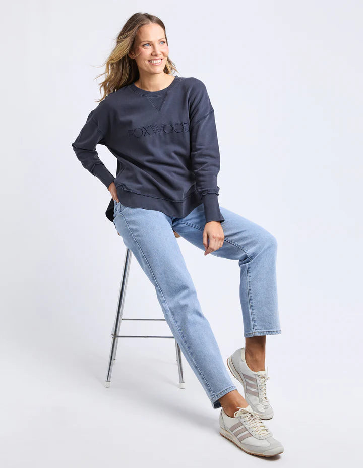 Washed Simplified Crew - Navy-Foxwood-The Washed version of our Best Selling Simplified Crew. This crew is the perfect throw over for your everyday wardrobe. With its round neck, hi-lo hemline, side splits with raw edging & the classic Foxwood logo, you are going to want one in every colour. The Washed version has a vintage look for that much-loved look from the get-go. Front chest embroidery Raw edge detail Curved hem 100% Cotton Model is wearing a Size 10-Pash + Evolve