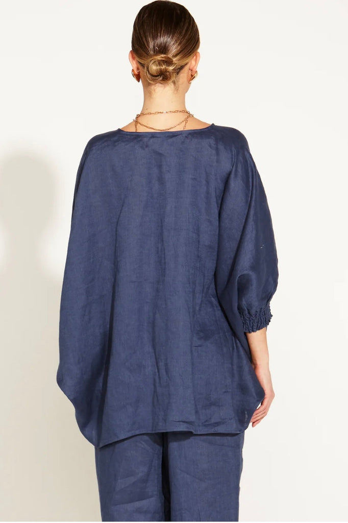 A Walk In The Park Linen Oversized Batwing Top - Navy-FATE + BECKER-Indulge in the epitome of chic comfort with our A Walk in the Park Linen Oversized Batwing Top. The relaxed fit effortlessly combines style and ease, while the batwing sleeves create an artistic silhouette that embraces your individuality. Adorned with shirred cuffs, this top is a symphony of fashion and comfort. Elevate your wardrobe with this oversized masterpiece -Relaxed Fit/ Oversized -Batwing Sleeves -Batwing Sleeves -Shirred Cuffs Fa