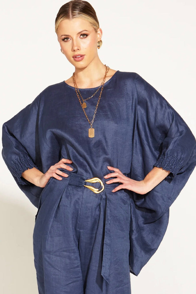 A Walk In The Park Linen Oversized Batwing Top - Navy-FATE + BECKER-Indulge in the epitome of chic comfort with our A Walk in the Park Linen Oversized Batwing Top. The relaxed fit effortlessly combines style and ease, while the batwing sleeves create an artistic silhouette that embraces your individuality. Adorned with shirred cuffs, this top is a symphony of fashion and comfort. Elevate your wardrobe with this oversized masterpiece -Relaxed Fit/ Oversized -Batwing Sleeves -Batwing Sleeves -Shirred Cuffs Fa