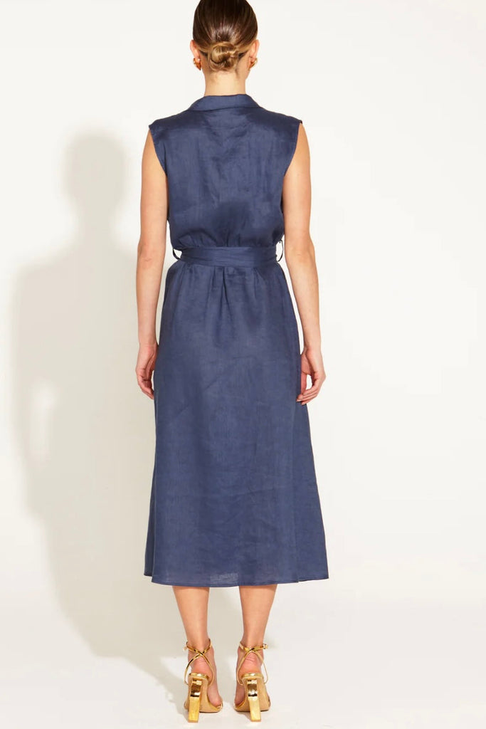 A Walk In The Park Linen Sleeveless dress - navy-FATE + BECKER-Step into timeless elegance with our A Walk in the Park Linen Sleeveless Midi Dress a refined masterpiece in relaxed sophistication. The faux-wrap design adds a touch of artistry to the silhouette, while a gleaming gold buckle, accompanied by a self-material belt, cinches at the waist for a personalized, graceful fit. Embrace the allure of sleeveless chic in this enchanting dress that effortlessly merges comfort with couture. Elevate your style 