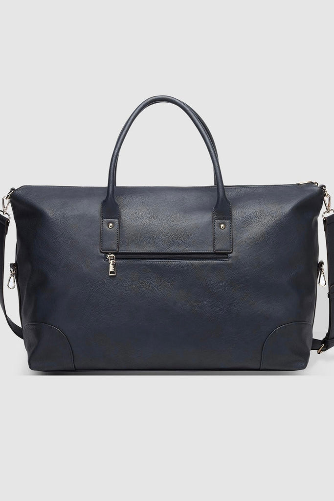 Alexis Weekender Travel Bag - Navy-Louenhide-The Louenhide Alexis Navy Weekender Travel Bag is a perfect carryall for overnight or weekend adventures! Feel luxe and invest in a quality, soft, and easy clean vegan leather Louenhide travel bag. Wide opening and spacious, this weekender is just the right size to fit your travel essentials. Carry this women’s travel bag effortlessly by the top handles, or wear on your shoulder with the detachable extension strap, for added comfort. Now comes with a handy back z