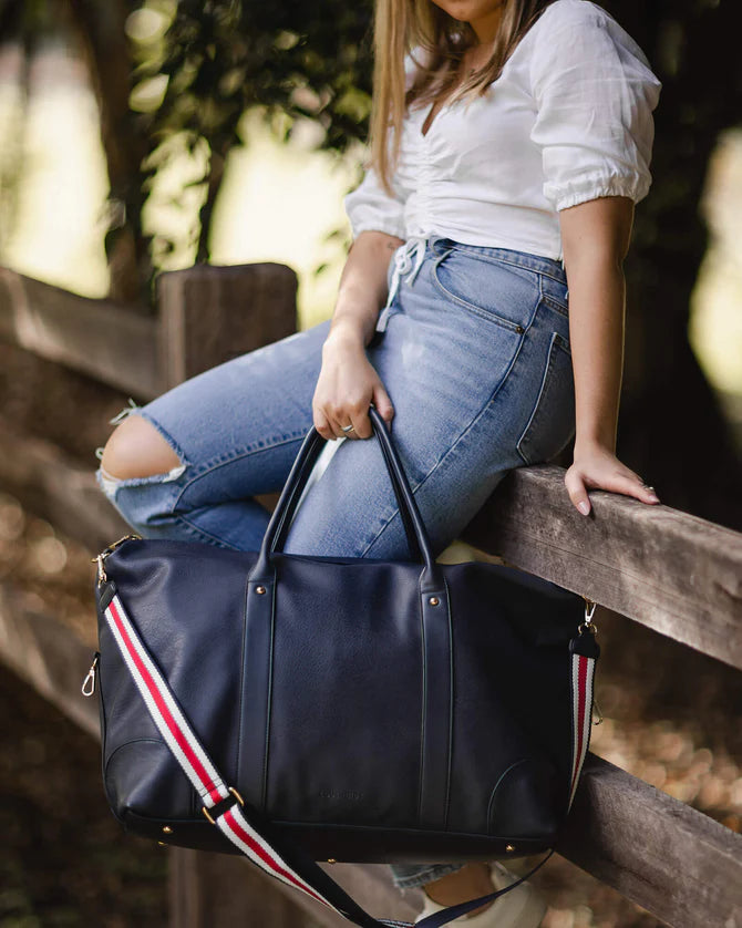 Alexis Weekender Travel Bag - Navy stripe-Louenhide-The Louenhide Alexis Navy Weekender Travel Bag with Stripe Strap is a perfect carryall for overnight or weekend adventures! Feel luxe and invest in a quality, soft, and easy clean vegan leather Louenhide travel bag. This new design is a sporty twist on a Louenhide best seller, now featuring a fun statement stripe webbing extension strap. Wide opening and spacious, this weekender is just the right size to fit your travel essentials. Carry the bag effortless