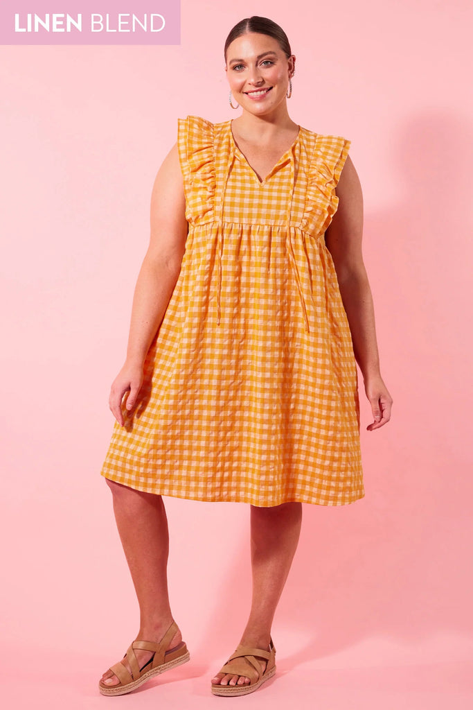 Alfresco frill dress - sunrise-Isle of Mine-Get ready to turn heads in the oh-so-adorable Alfresco Frill Dress! It's the perfect blend of fun and playfulness, with a lively gingham print and lightweight linen blend fabrication. With a breezy knee-length design, a V-neck with a self-tie and frilled sleeves, you'll want to wear it on repeat all summer! Perfect for brunching or picnicking, pair it with sneakers or sandals. FEATURES: V-neck with self-tie Frilled sleeves Single tier with gathering Inseam pockets