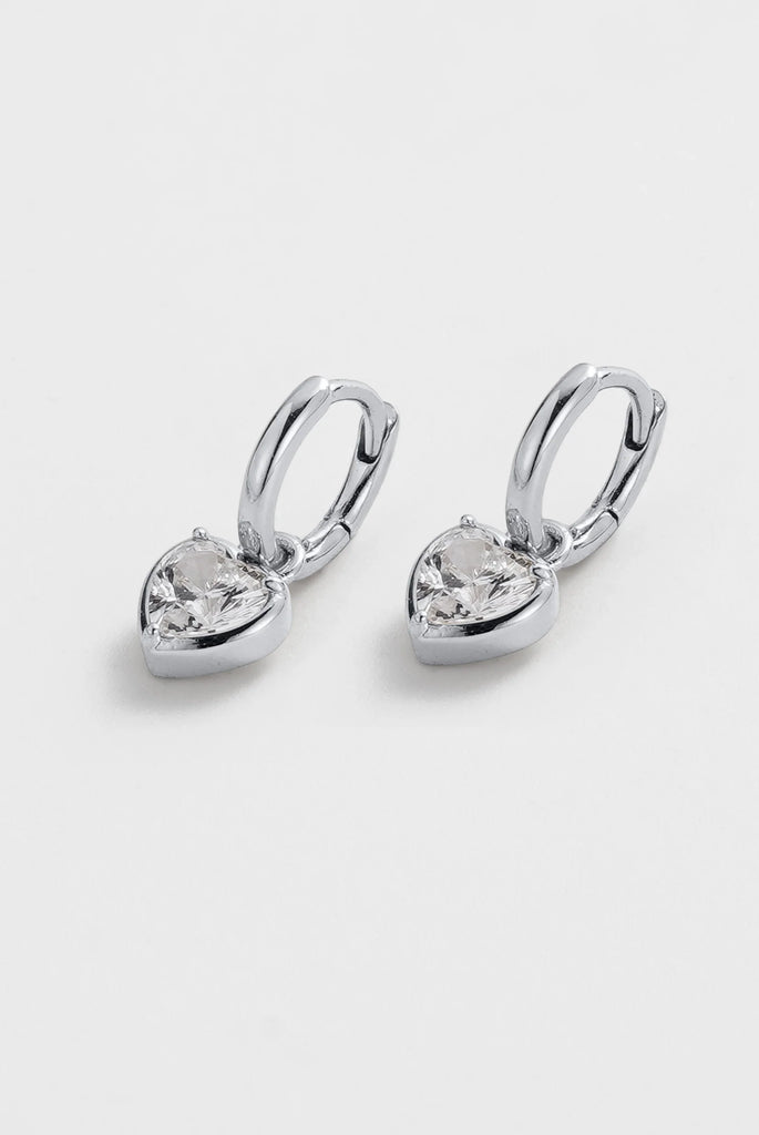 Amor Earring - Silver-Zafino-The Amor Earrings are a modern take on a classic love motif. Featuring a sparkling crystal heart charm suspended from a sleek gold huggie, these earrings bring just the right amount of shine to your everyday look. Designed in a waterproof, tarnish-resistant finish, they’re made to be worn on repeat — from day to night, beach to bar. Wear them solo for a subtle statement or style them with the Amor Necklace for a perfectly matched set. Metal: Silver Plated on BrassDimensions: 8mm