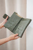 Arlo travel wallet - olive green pebble-Baleka Leather-Designed for the modern traveller, the Arlo Travel Wallet blends sleek style with smart functionality. Crafted for convenience, it features a press-stud closure for quick access and dual zip compartments to keep your essentials securely organized. The Arlo wallet includes an attachable strap, allowing you to wear it comfortably across the body — perfect for on-the-go adventures or everyday errands Whether you’re boarding a flight or exploring a new city