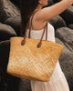 Ava Basket Tote - Natural Raffia-Louenhide-The Ava Natural Raffia Basket Tote is your effortlessly stylish plus-one for sun-drenched days and spontaneous summer moments. Crafted from natural raffia in a structured open-top basket silhouette, she blends relaxed elegance with warm-weather practicality - perfect for everything from seaside escapes to spritz-soaked afternoons in the sun. Her slim, elongated handles in smooth tan vegan leather add a refined contrast and comfortable carry, whether worn over the s